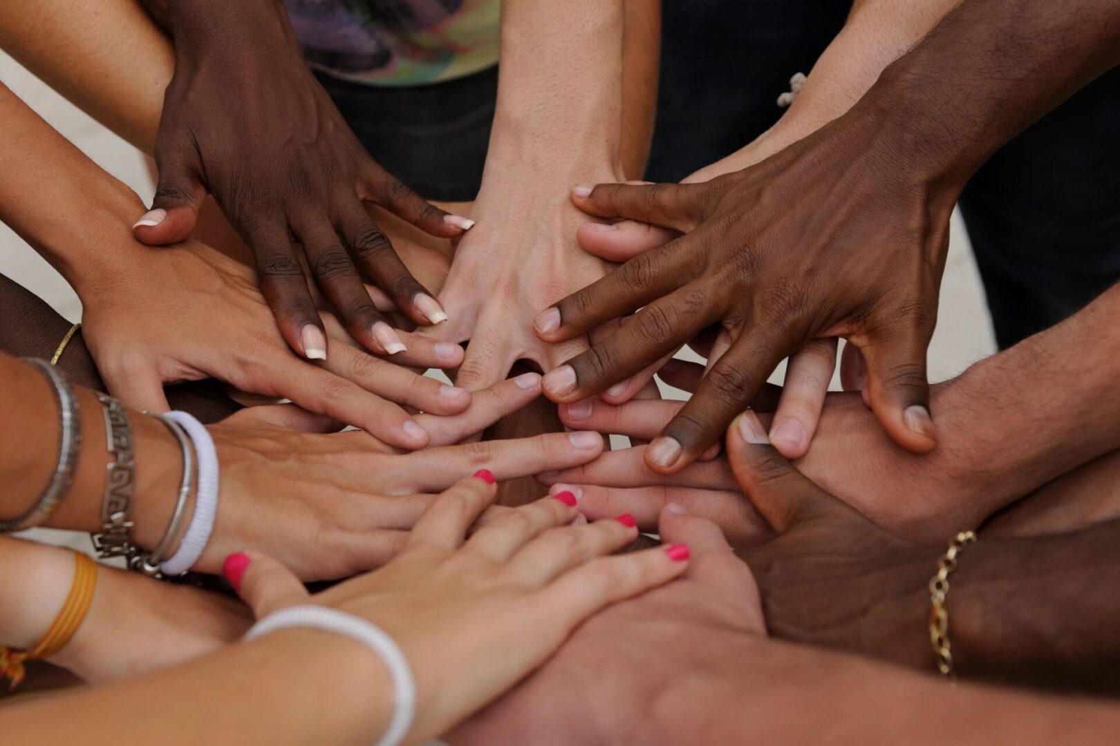 A group of people with their hands together.