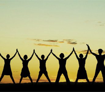 A group of people holding hands in the air.