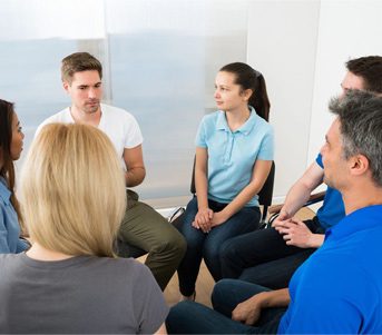 A group of people sitting in a circle.